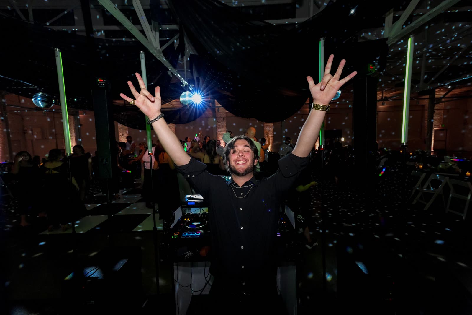 Debeljak Productions DJ celebrating on stage in front of a packed wedding dance floor